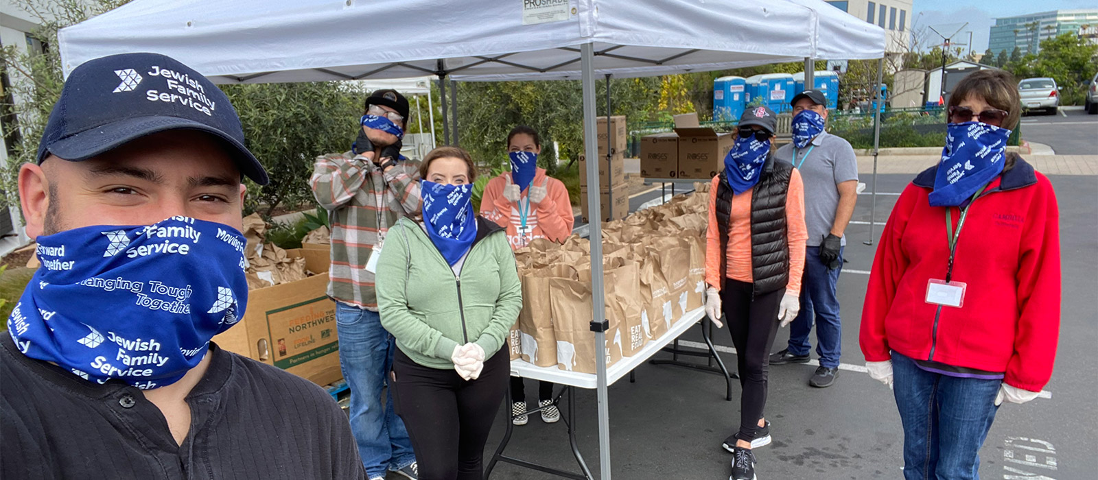 banner photo of JFS volunteers bagging food in masks